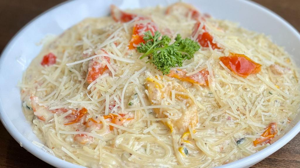 Garlic Parmesan Capellini · Pancetta, sundried tomatoes and fresh herbs in our signature garlic parmesan sauce tossed with capellini.