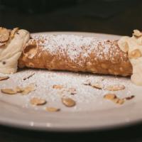 Cannoli · Sweetened ricotta cream filling with chocolate chips, piped into a crisp pastry shell, garni...
