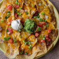 Anahuac Nachos · Crisp corn tortillas topped with melted cheese, refried beans, jalapenos, sour cream and gua...