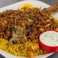 Lamb Kabsa · 1 Lamb shank on top of flavorful yellow rice. Various vegetables and toppings such as carrot...