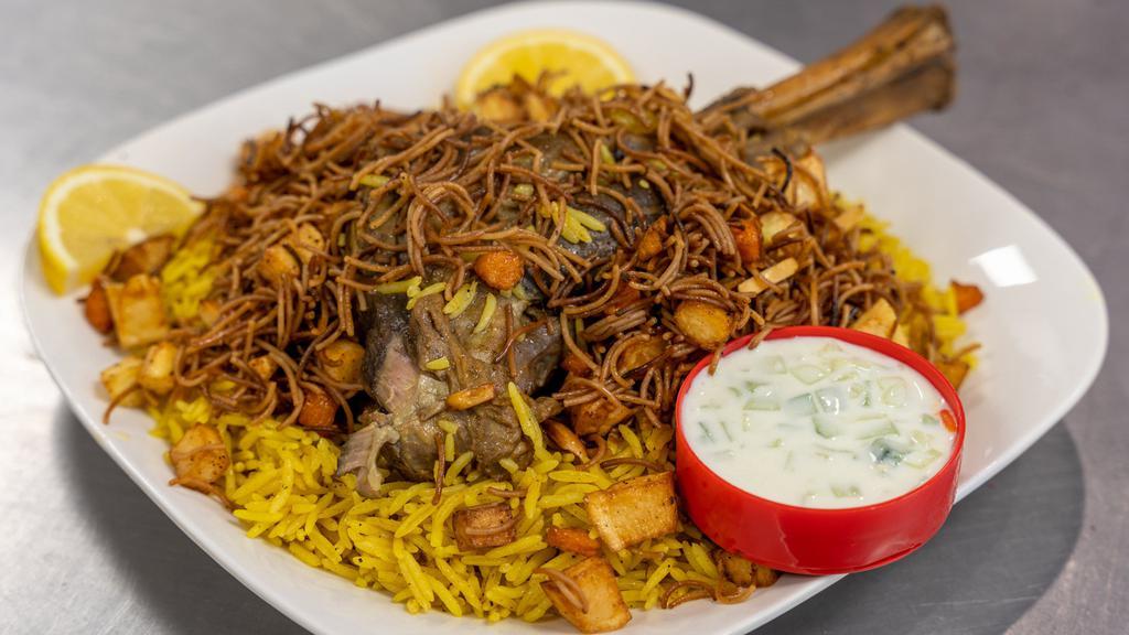 Lamb Kabsa · 1 Lamb shank on top of flavorful yellow rice. Various vegetables and toppings such as carrots and potatoes mixed into the rice. ***includes nuts and raisins. With a side of tzatziki.