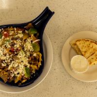 Gyros Skillet · Two eggs scrambles with gyros meat, green peppers, onions, tomatoes, on a bed of hashbrowns ...