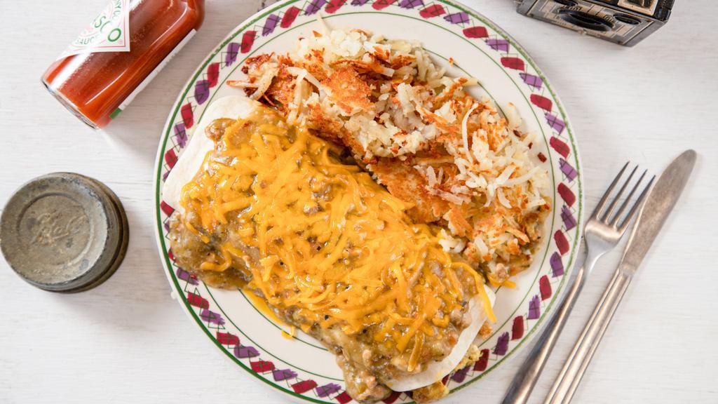 Hasty Burrito · Four scrambled eggs cooked with sausage and onions wrapped in a flour tortilla, smothered in homemade green chili or salsa, and topped with cheddar cheese. Served with fresh hash browns.