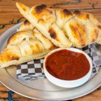 Sourdough Bread Twists · Our homemade sourdough bread twist baked to perfection. Served with a side of red sauce