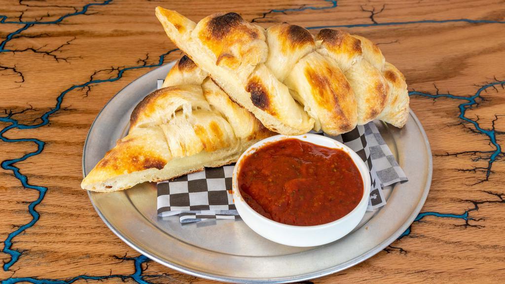 Sourdough Bread Twists · Our homemade sourdough bread twist baked to perfection. Served with a side of red sauce