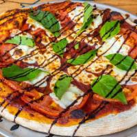 Alpine Margherita · In-house red sauce, fresh mozzarella, basil leaves, tomato, balsamic drizzle, served on our ...