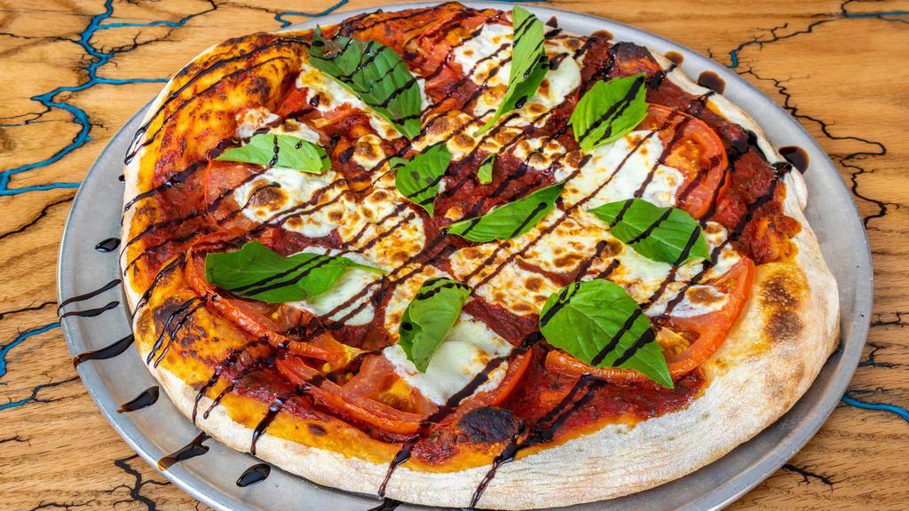 Alpine Margherita · In-house red sauce, fresh mozzarella, basil leaves, tomato, balsamic drizzle, served on our sourdough crust.