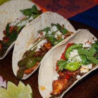 Tacos Autenticos · 3 tortillas neatly filled with marinated top sirloin, sauteed pepper and onions. Topped with...