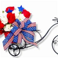 American Glory · Made with natural flowers.

This arrangement is all around shape   made with
6 red roses
6 w...