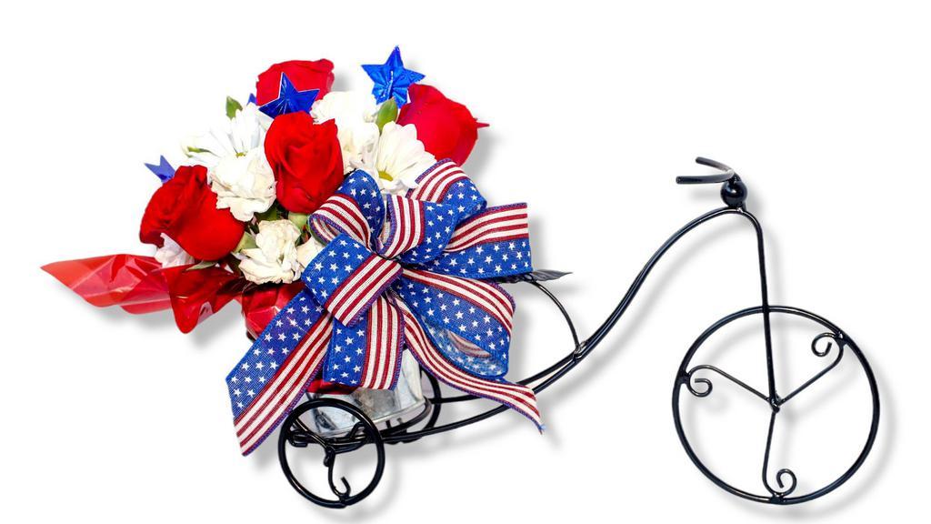 American Glory · Made with natural flowers.

This arrangement is all around shape   made with
6 red roses
6 white companion flowers (daisies, alstroemerias or carnations) on a bicycle flowerpot decorated with a Patriotic Bow
Premium
Add a balloon and a bag of chocolates
Deluxe
Also Add 6 more roses