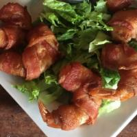 Bacon Wrapped Prawn Appetizer · Six large prawns wrapped with hickory smoked bacon. Quick fried and served with a jalapeño m...