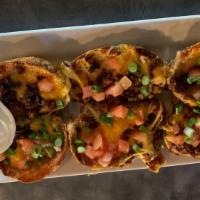 Potato Skins · Topped with bacon, cheese, diced tomato and green onions.