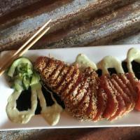 Seared Ahi Tuna · Sesame crusted tuna, seared and served medium rare. Accompanied with marinated cucumbers and...