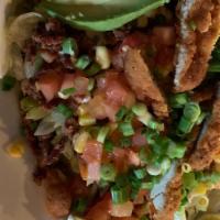 Fried Chicken Salad · Topped with crisp chicken, bacon, tomatoes, egg, avocado, corn and green onions. Drizzled wi...