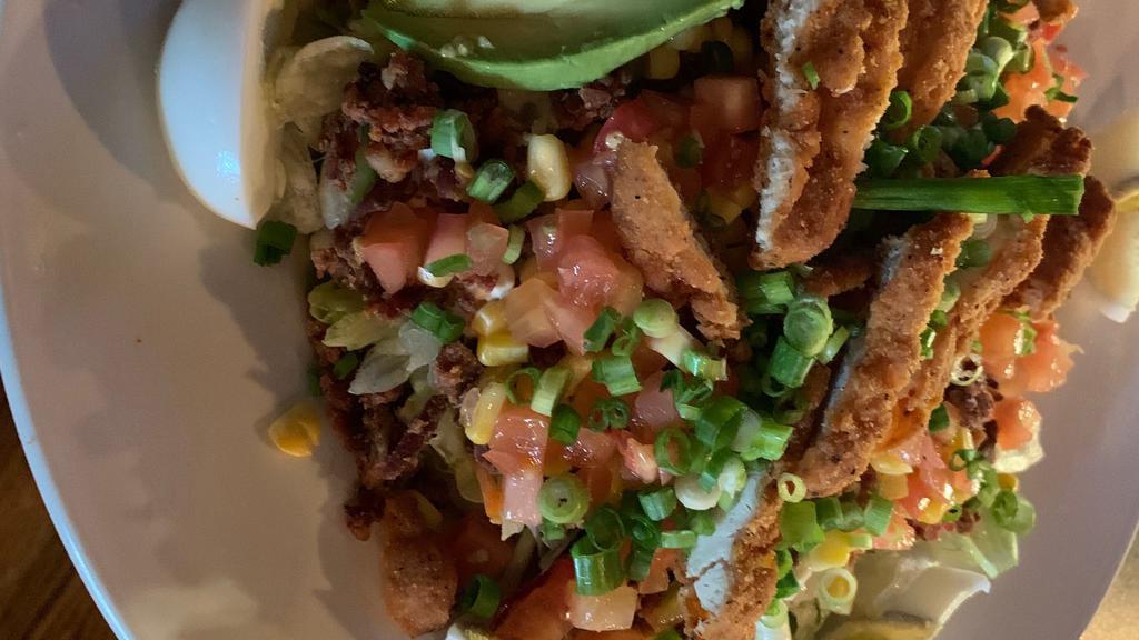 Fried Chicken Salad · Topped with crisp chicken, bacon, tomatoes, egg, avocado, corn and green onions. Drizzled with french and honey mustard dressings.