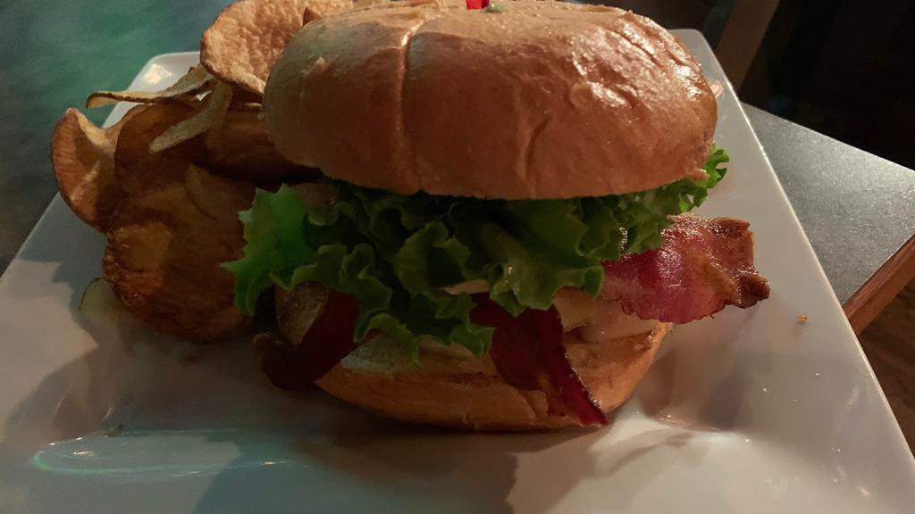 California Burger · Crisp bacon, fresh sliced avocado, swiss cheese, tomatoes, crisp lettuce, red onions and mayo. Served on a brioche bun with fries or homemade potato chips.