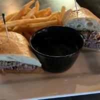 Prime Rib Dip Sandwich · Sliced Prime rib piled high on a fresh baguette bun. Served with au jus for dipping’ and fri...
