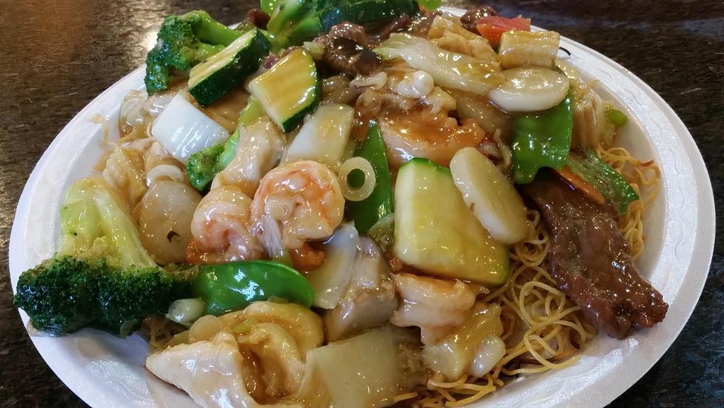 Hong Kong Style Chow Mein · Crispy pan-fried noodle with chicken, beef, shrimp, and veggles topped with light garlic sauce.