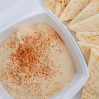 Pita & Hummus · Creamy house hummus with a dash of paprika served with two warm pitas.