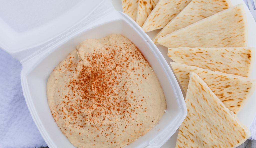 Pita Bread & Hummus · Creamy house hummus with a dash of paprika, served with two warm pitas.