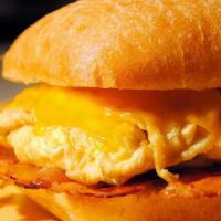 Ciabatta Breakfast Sandwich · Your choice of bacon, ham, steak, or sausage. Served with two fluffy eggs, melted cheddar, a...