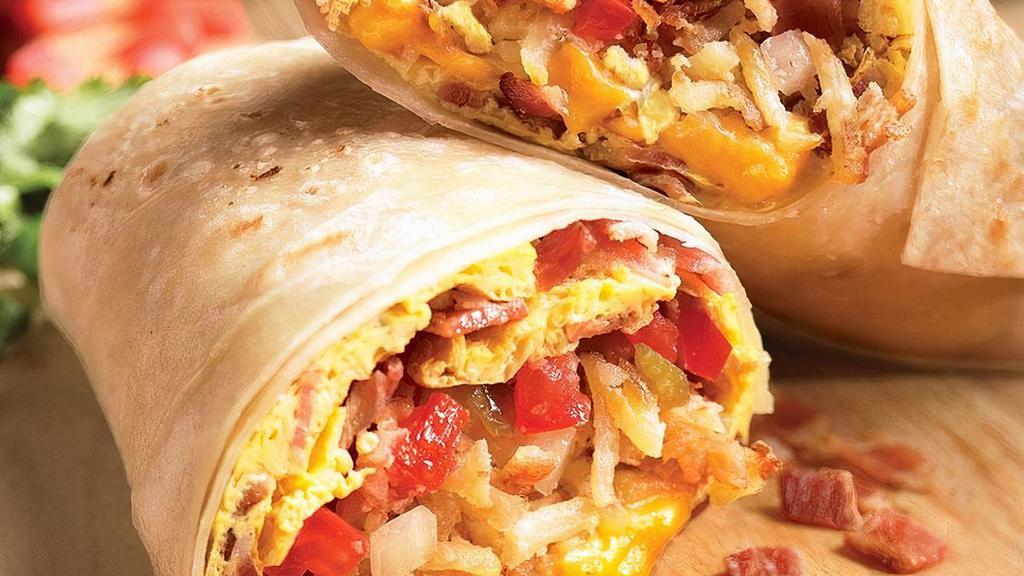Breakfast Burrito · Your choice of bacon, ham, steak, or sausage, fresh scrambled eggs, cheddar jack cheese, diced potatoes, tomatoes, onions, and black beans. All rolled up in a warm flour tortilla.