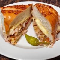 Turkey Melt · Grilled sliced turkey, topped with melted Swiss cheese, onions, pickles, tomatoes & our hous...