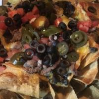 Nachos · Topped with mixed cheese, Southwest queso, tomatoes, black olives, jalapeño peppers, black b...