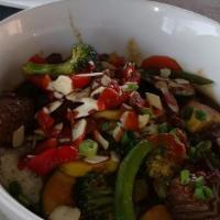Korean Bbq Bowl · Grilled steak with jasmine rice, steamed veggies, pear-apple soy, Sriracha, green onions & t...