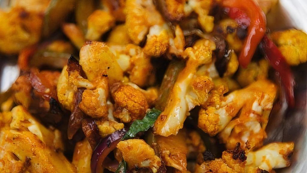 Roasted Cauliflower (Gf) · Roasted cauliflower with sautéed onions and bell peppers, tossed in a Indo-Chinese sweet and spicy sauce