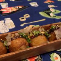 Takoyaki · 5 pieces deep fried octopus fritters topped with eel sauce, spicy mayo and bonito flakes.