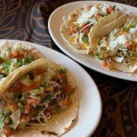 Fish Or Kalua Pork Tacos · 2 tasy tacos filled with lightly fried panko dusted seasonal fresh fish, or our homemade kal...