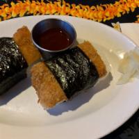 Chicken Katsu Musubi · Our homemade chicken katsu fried golden brown and placed on a block of musubi rice and wrapp...