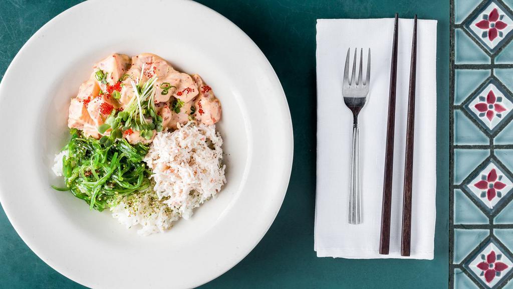 Creamy Salmon Poke Bowl · Salmon, avocado, masago with green onion mixed in a creamy spicy poke sauce. Comes with sushi rice, krab, seaweed salad and topped with furikake and sesame seeds.