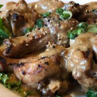 Adobo · Chicken drumette's slowly braised with garlic, bay leaves, shoyu and coconut milk, then gril...