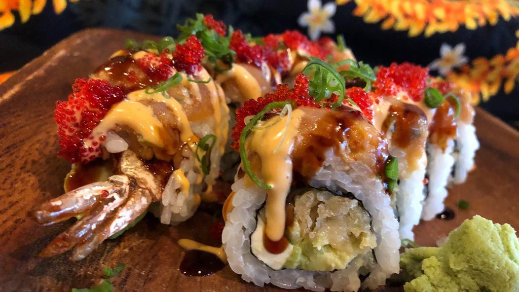 Volcano Roll · Tempura shrimp, cream cheese, cucumber and avocado, topped with spicy tuna, eel sauce, spicy mayo, green onion and tobiko.

Roll is RAW