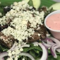 Steakhouse Salad · Fresh greens, red onion, cucumber, and blue cheese crumbles, topped with grilled steak strip...