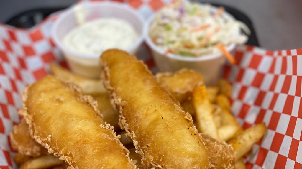Fish & Chips · Beer battered halibut cooked to a golden brown with French fries and coleslaw served with tartar sauce for dipping.