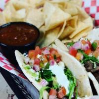 Burnt End Tacos · Hardwood-smoked brisket, lettuce, pico De gallo, queso fresco, and sour cream finished with ...