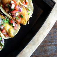 Vegan Crispy Avocado Street Taco · Three mini corn tortillas filled with crispy beer battered avocado, cabbage slaw, roasted ch...