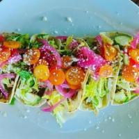 Duck A L'Orange Tacos · slow braised duck, brussels slaw, pickled red onion & cotija cheese, alejandros corn tortill...
