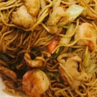 Kura Yakisoba · Stir fried chicken, shrimp, Yakisoba noodles, served with green cabbage, sliced carrots, oni...