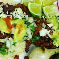 Tacos Al Pastor · Carne al pastor grilled and dice on a corn tortilla, pico de gallo, cabbage, onions, cilantr...