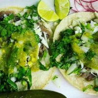 Taco De Cabeza · Cabeza meat on a corn tortilla with cabbage, onions, and cilantro. Served with lemons and ra...