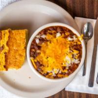 Homemade Chili · Served with cheddar and diced onions and a hunk of homemade cornbread.