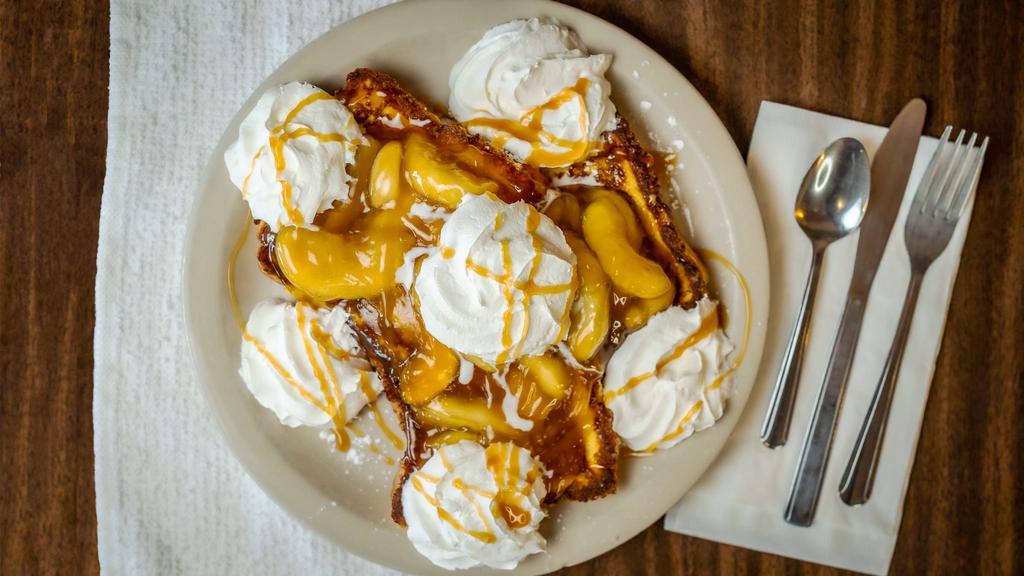 Apple French Toast · Thick egg bread dipped in our famous batter topped with apple compote, whipped cream, and powdered sugar.