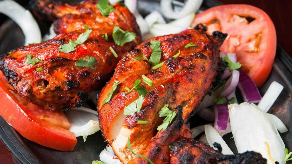Chicken Tandoori · Half chicken marinated in a mixture of yogurt, garlic, ginger, and other select spices, and grilled in the tandoor. Comes with a side of rice.