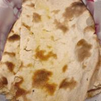 Tandoori Naan · Leavened bread of fine flower baked in the Clay Oven, served piping hot.