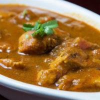 Chicken Curry · Boneless chicken tender cooked in a rich curry of onions, tomatoes, ginger, garlic and spice...