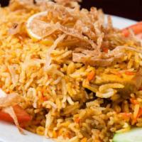Chicken Biryani · Rice cooked with pieces of chicken, sautéed in herbs & spices then cooked with nuts.